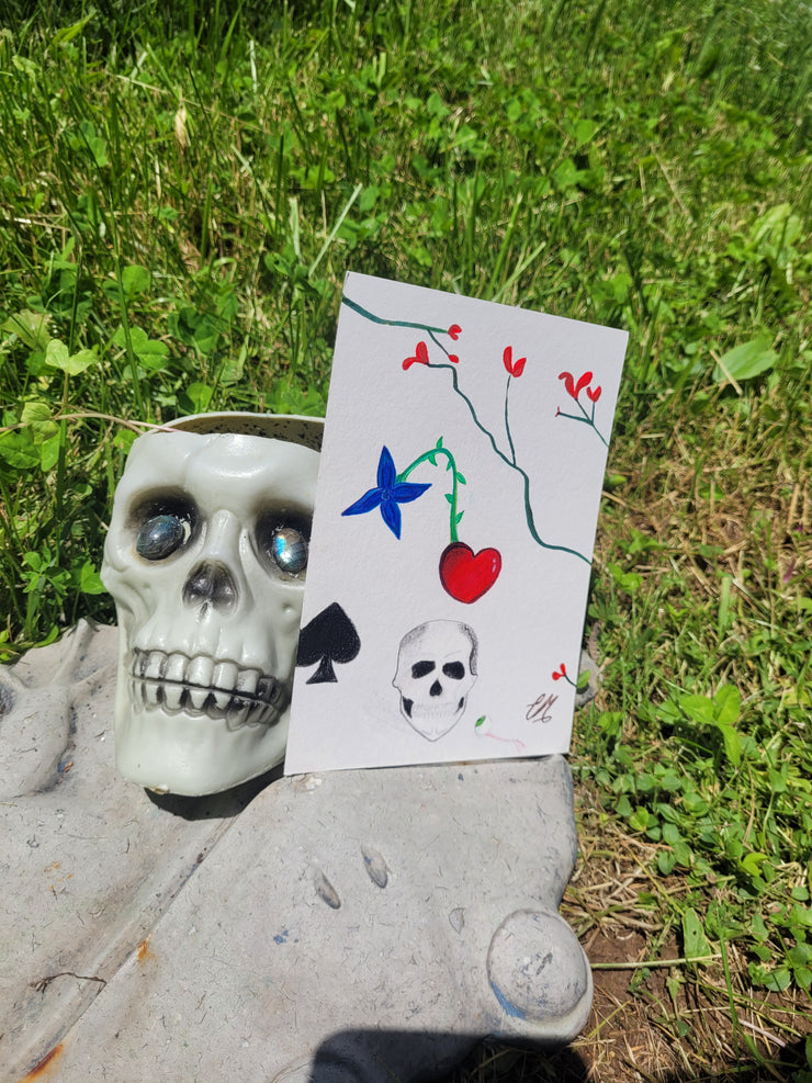 Drawing-skull-eyeball-flowers-vines-branches-spade